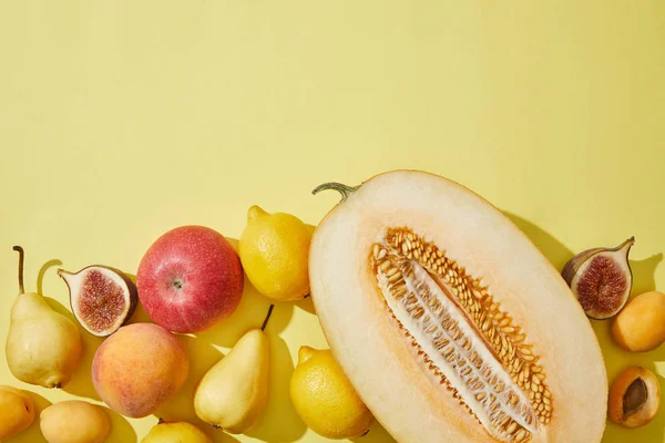 Top View Halved Melon Fresh Ripe Fruits Yellow Background — стоковое фото